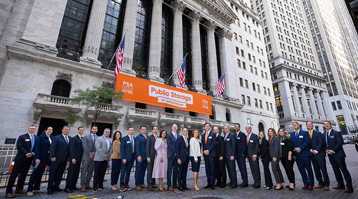 public storage team poses in front of new york stock exchange building